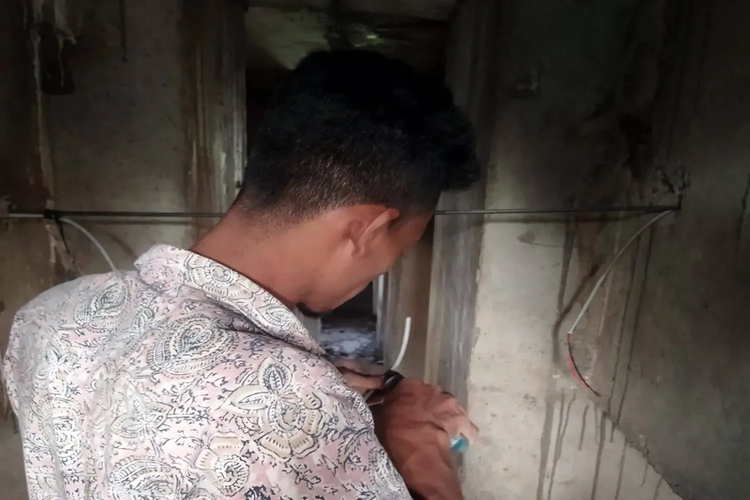Technician performing CCTV camera wiring installation work at Kalshi Flyover project